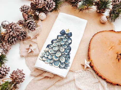 CapableByDesign oyster shell Christmas tree with navy bow pillows and matching towels