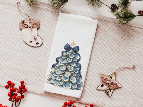 CapableByDesign oyster shell Christmas tree with navy bow pillows and matching towels